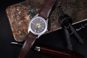 Todd Reed watch made with 18k yellow gold, sterling silver and stainless steel on a leather strap